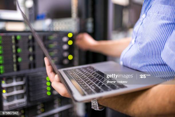 Engineer in the server room close-up. Photo taken at a Data Center in Bulgaria, Eastern Europe.